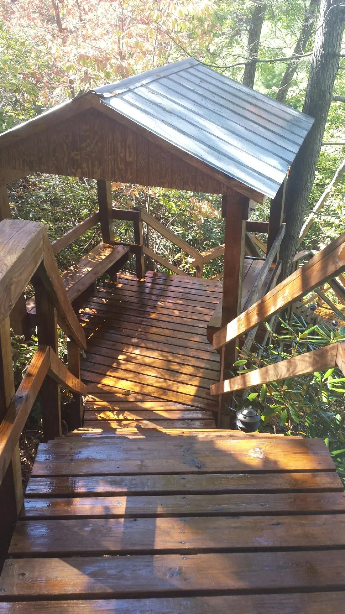 Freshly stained wood walkway and covered shelter with a metal roof in West Milford